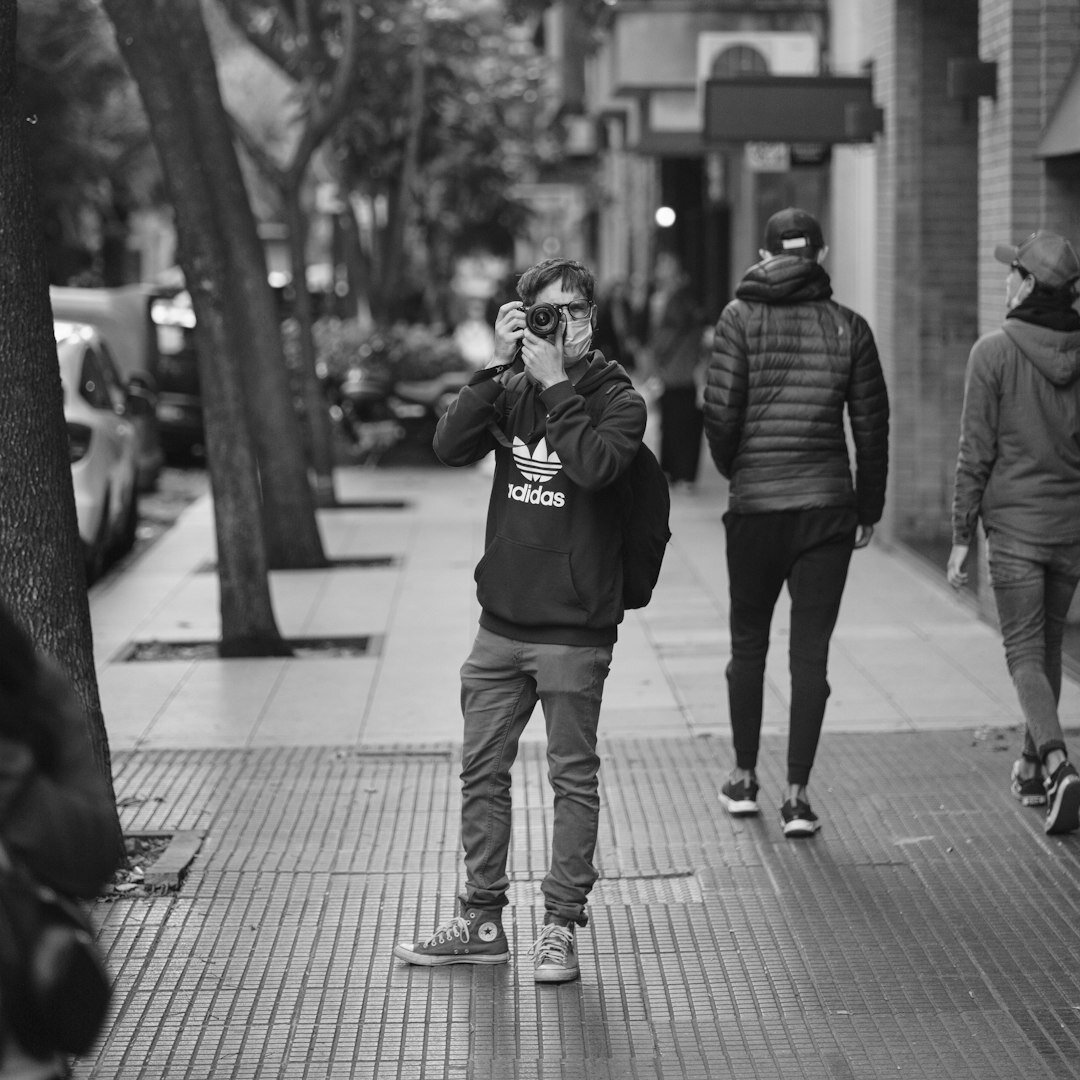 Photojournalist holding a camera in an urban street